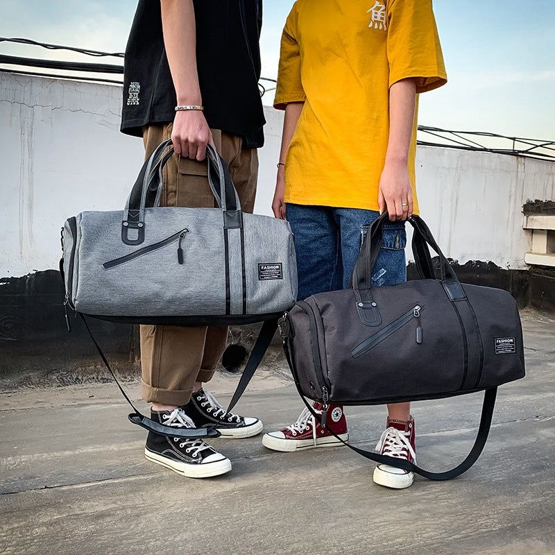 Wet/Dry Gym Duffel in Gray and Black, carried by hand