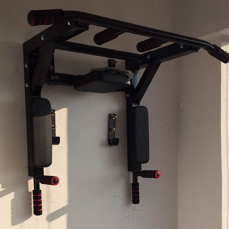 Wall-Mounted Pull-Up and Dip Station in black, mounted on a wall